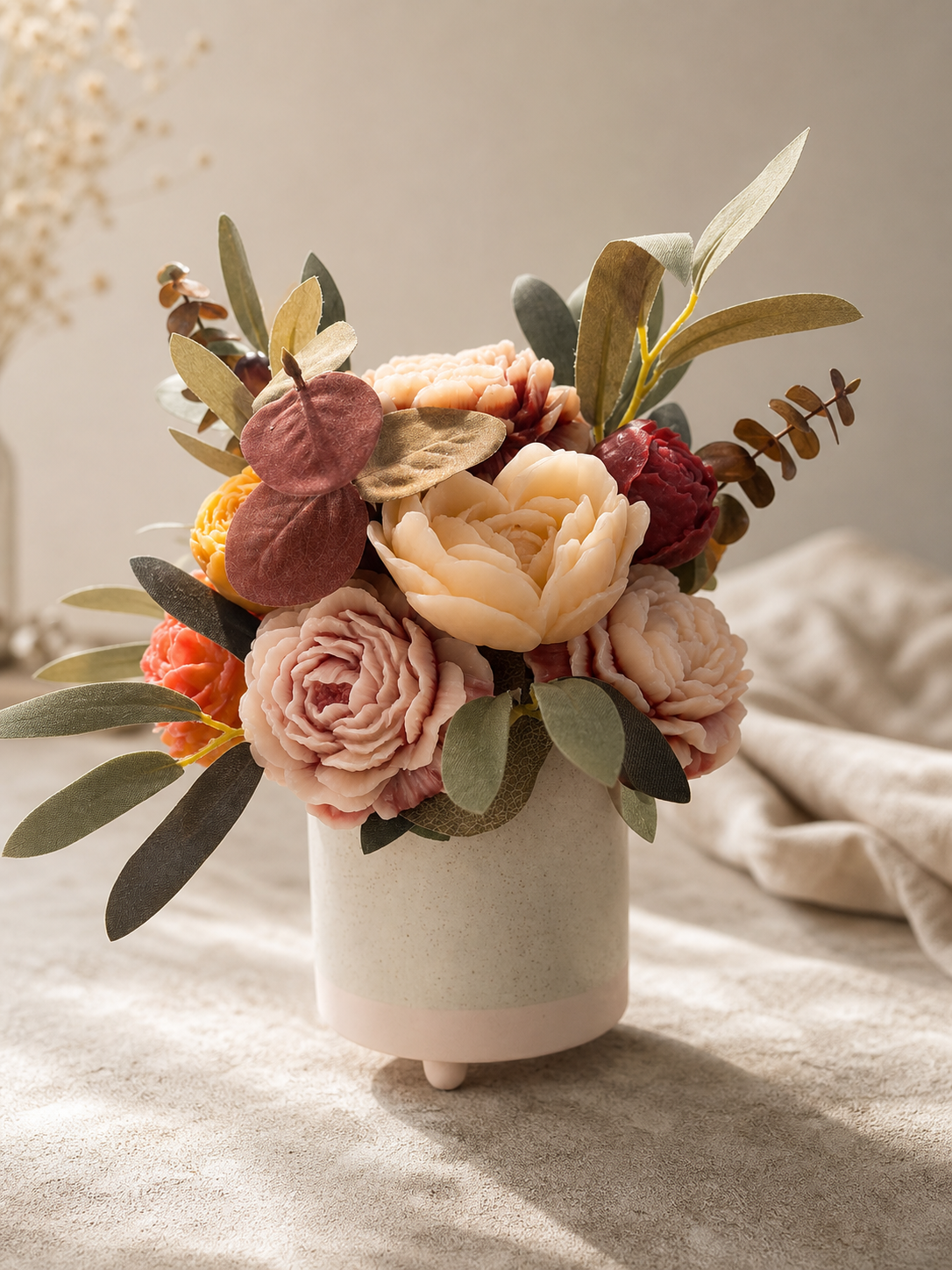 Cream blush burgundy and sage scented wax floral arrangement in a footed ceramic vase